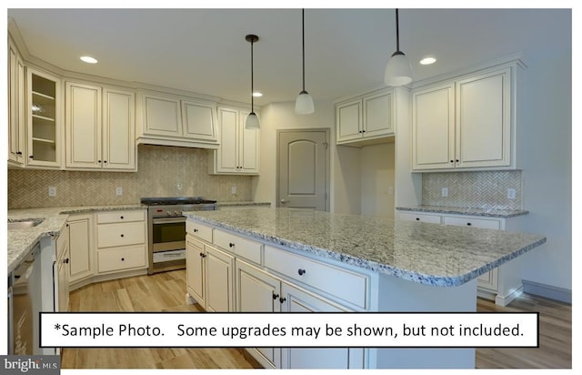 kitchen with a center island, decorative backsplash, hanging light fixtures, stainless steel appliances, and light stone counters