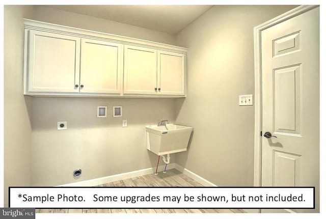 laundry area with cabinets, sink, hookup for a washing machine, hookup for an electric dryer, and light hardwood / wood-style flooring