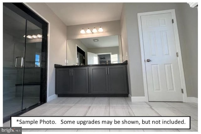 bathroom with tile patterned floors, an enclosed shower, and vanity