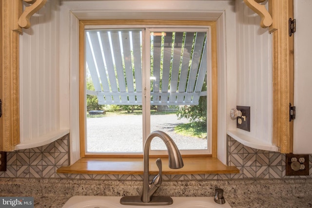 interior space with light stone countertops, a wealth of natural light, and sink