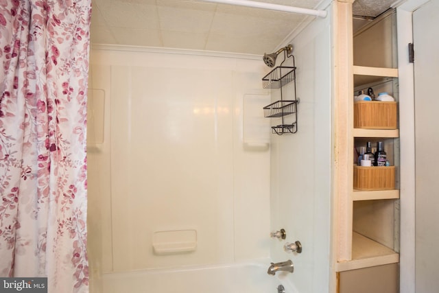 bathroom featuring shower / bath combo with shower curtain, ornamental molding, and a textured ceiling