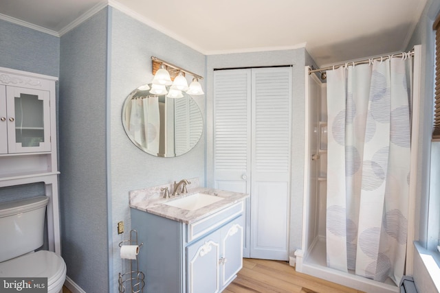 bathroom with a baseboard radiator, wood-type flooring, toilet, oversized vanity, and ornamental molding