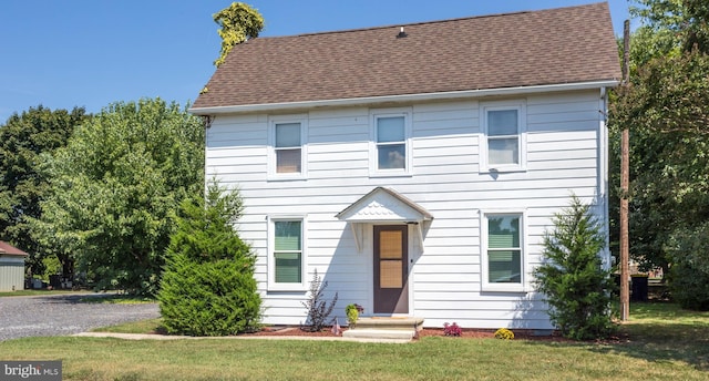 colonial home with a front lawn