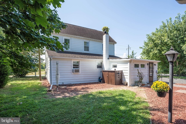 back of house featuring a lawn