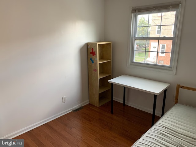 bedroom featuring dark hardwood / wood-style flooring