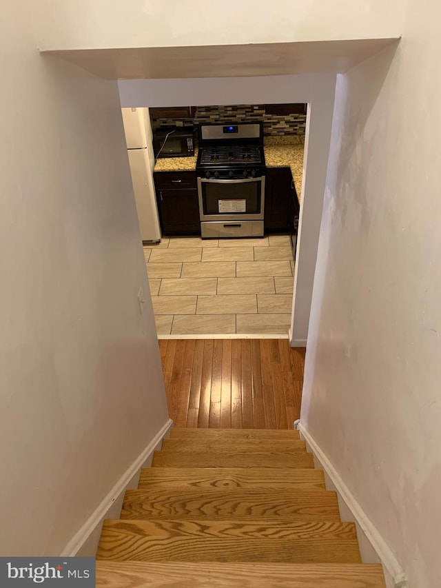 stairs with light hardwood / wood-style flooring