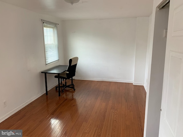 unfurnished office featuring dark wood-type flooring