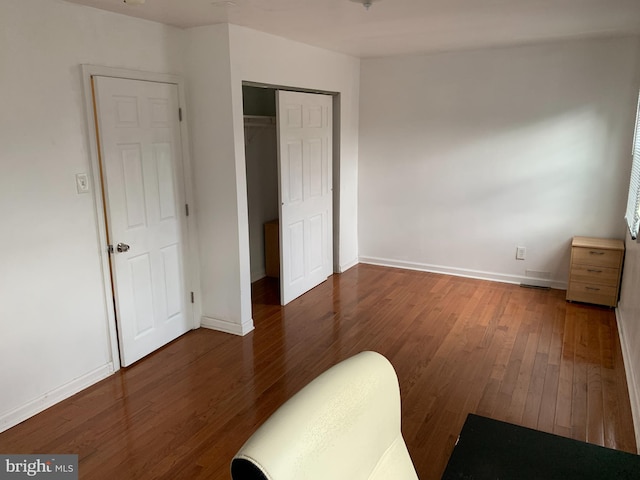 bedroom featuring a closet and dark wood-type flooring