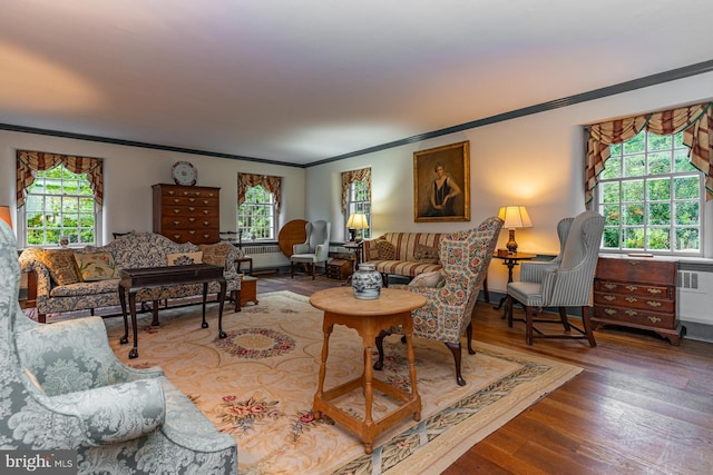 living room featuring plenty of natural light, ornamental molding, and hardwood / wood-style floors