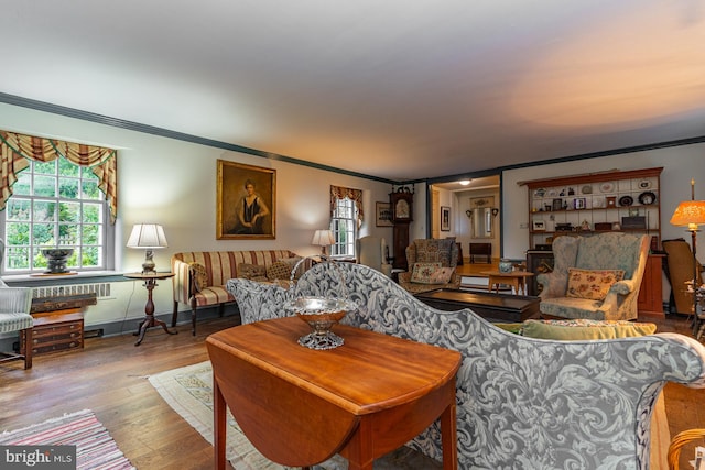 living room with ornamental molding and hardwood / wood-style floors