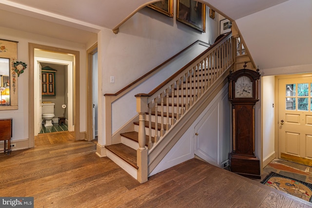 staircase with dark hardwood / wood-style floors