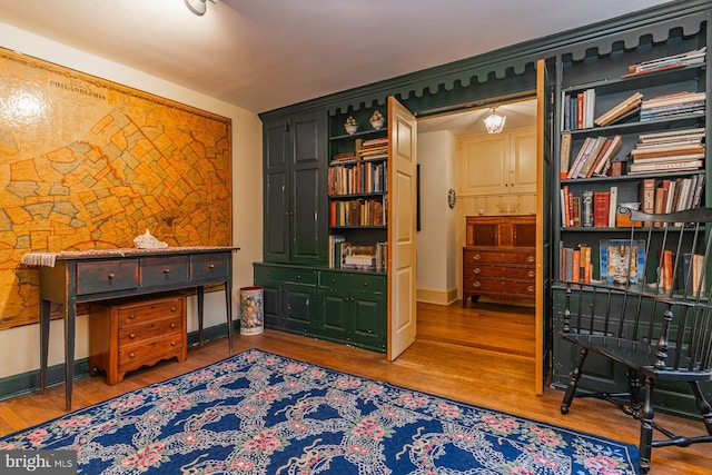 sitting room with wood-type flooring