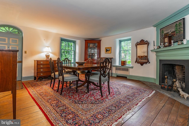 dining area featuring radiator and light wood-type flooring