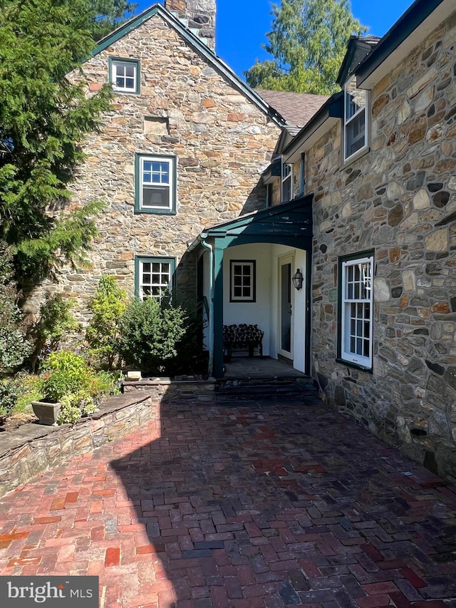 property entrance featuring a patio area