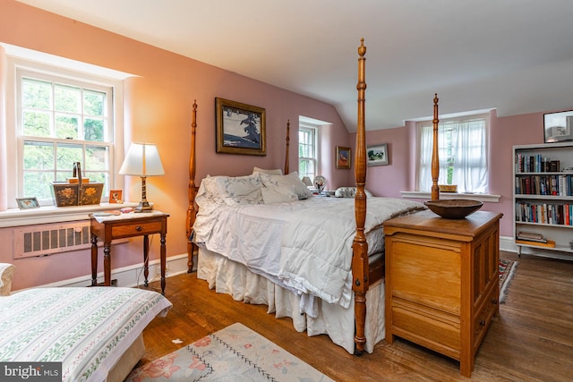 bedroom with dark hardwood / wood-style floors