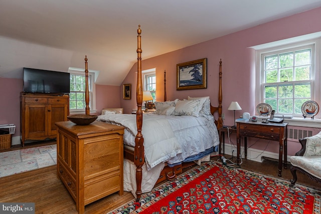 bedroom featuring dark hardwood / wood-style floors and vaulted ceiling