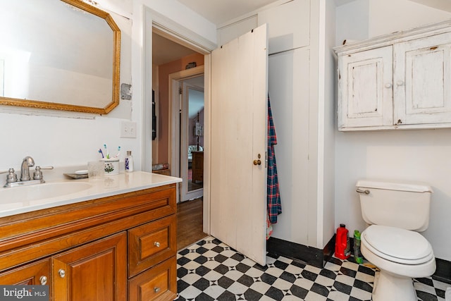 bathroom featuring vanity, tile floors, and toilet