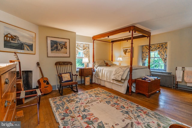 bedroom featuring dark hardwood / wood-style floors and radiator heating unit