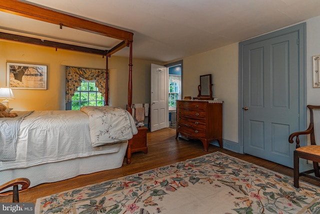 bedroom with dark hardwood / wood-style flooring