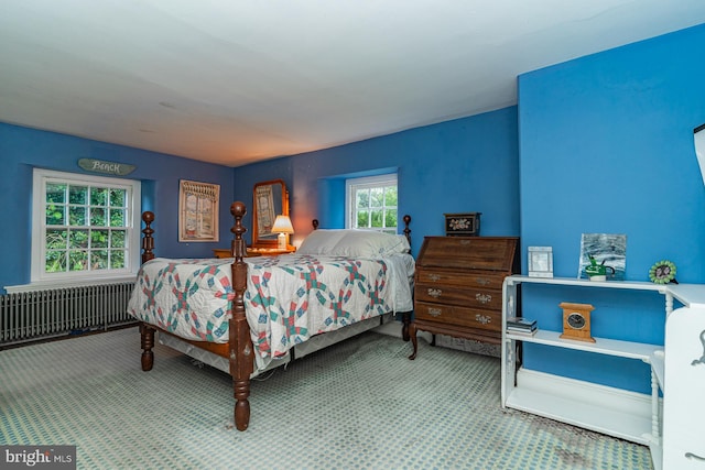 carpeted bedroom featuring radiator