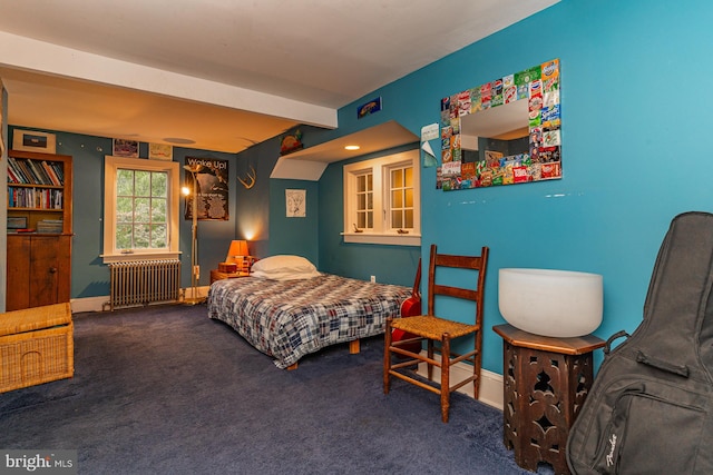 bedroom featuring radiator and dark carpet