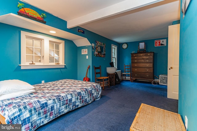 bedroom featuring beam ceiling and dark carpet