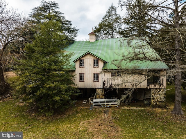 back of property featuring a lawn