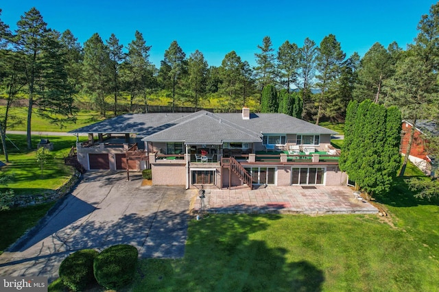 view of front of property featuring a front lawn and a patio area