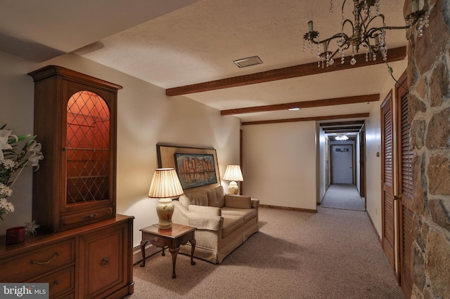 interior space featuring light colored carpet, a notable chandelier, a textured ceiling, and beamed ceiling