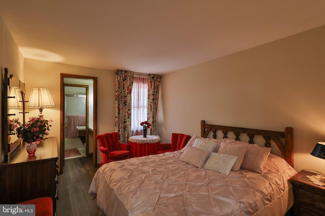 bedroom featuring dark hardwood / wood-style flooring and ensuite bath