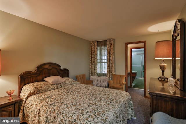 bedroom with dark colored carpet and ensuite bath