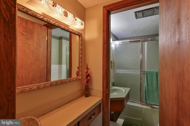 bathroom with oversized vanity and enclosed tub / shower combo