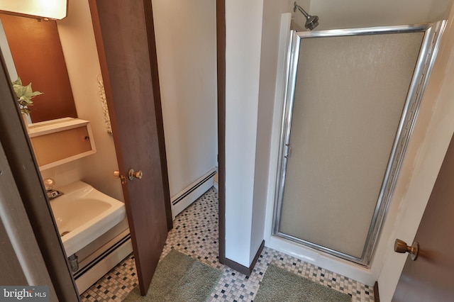 bathroom with a baseboard heating unit, tile floors, and an enclosed shower