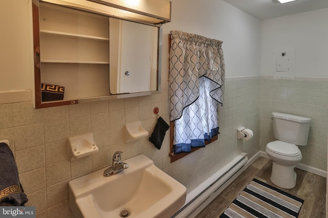 bathroom with tile walls, sink, and hardwood / wood-style floors