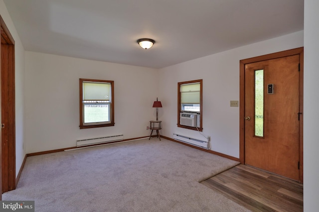 spare room featuring light colored carpet and a baseboard radiator