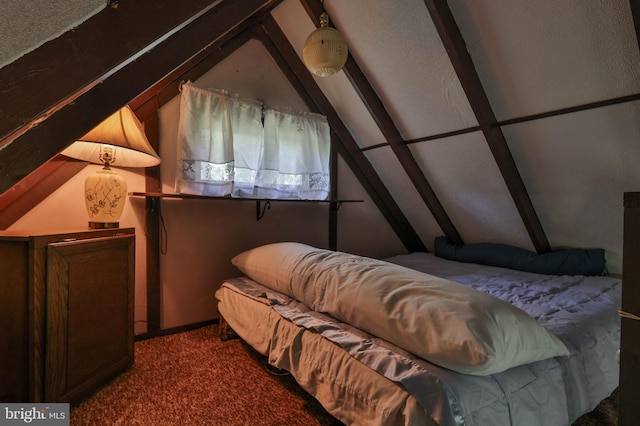 carpeted bedroom with lofted ceiling