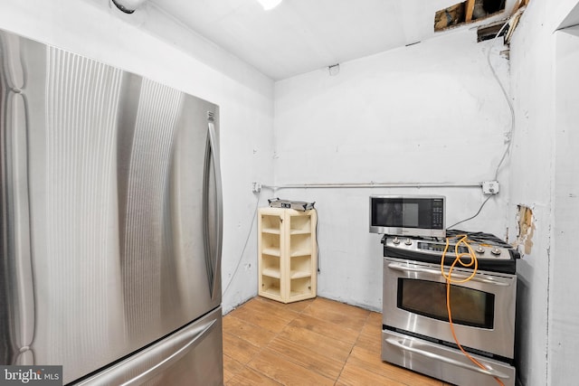 kitchen with wood-type flooring and stainless steel appliances