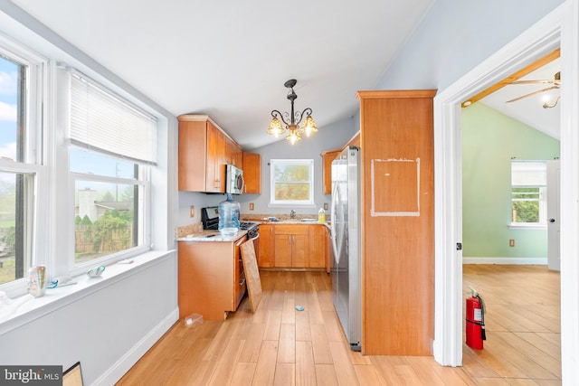 kitchen featuring stainless steel appliances, plenty of natural light, and lofted ceiling