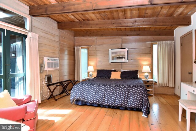 bedroom with wooden walls, wooden ceiling, vaulted ceiling with beams, and light hardwood / wood-style flooring