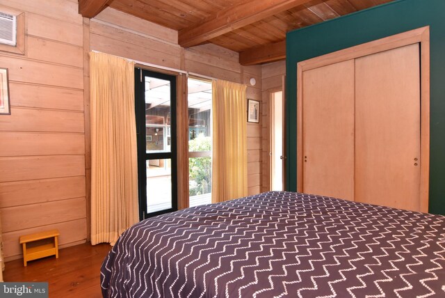 unfurnished bedroom with wood ceiling, dark hardwood / wood-style flooring, and beamed ceiling