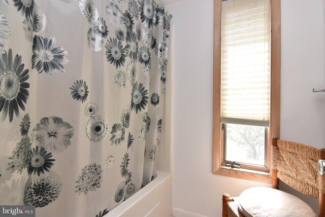 bathroom with toilet and shower / tub combo