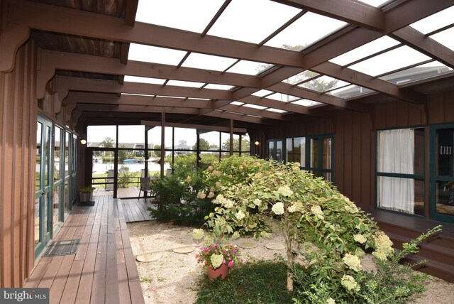 unfurnished sunroom featuring lofted ceiling