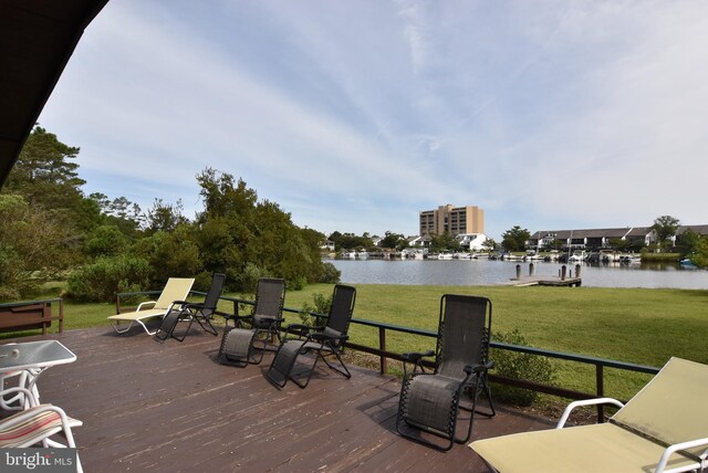 deck featuring a lawn and a water view