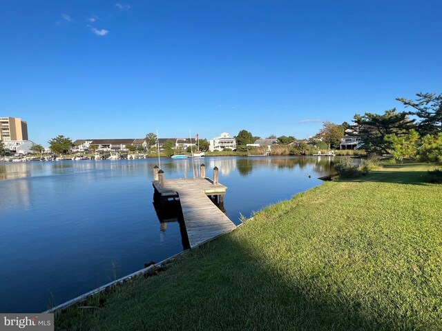 dock area featuring a lawn and a water view