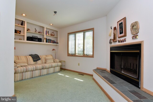 carpeted living room featuring a fireplace