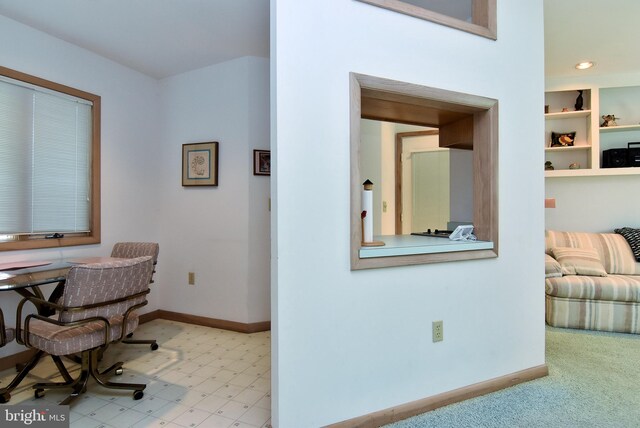 carpeted home office with built in shelves