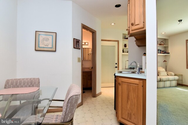 kitchen with sink and light tile floors