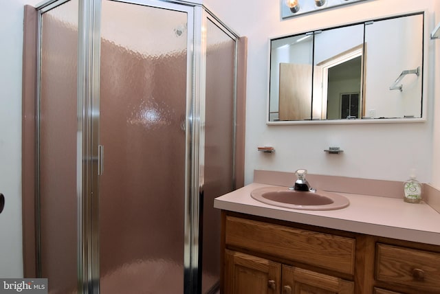 bathroom with walk in shower and vanity