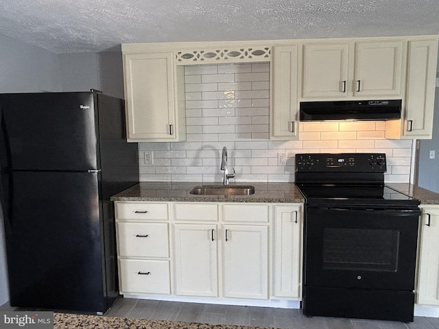 kitchen featuring sink, dark stone counters, fume extractor, backsplash, and black appliances