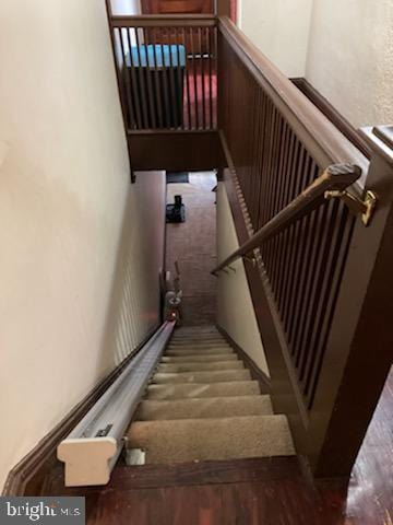 staircase featuring dark hardwood / wood-style flooring